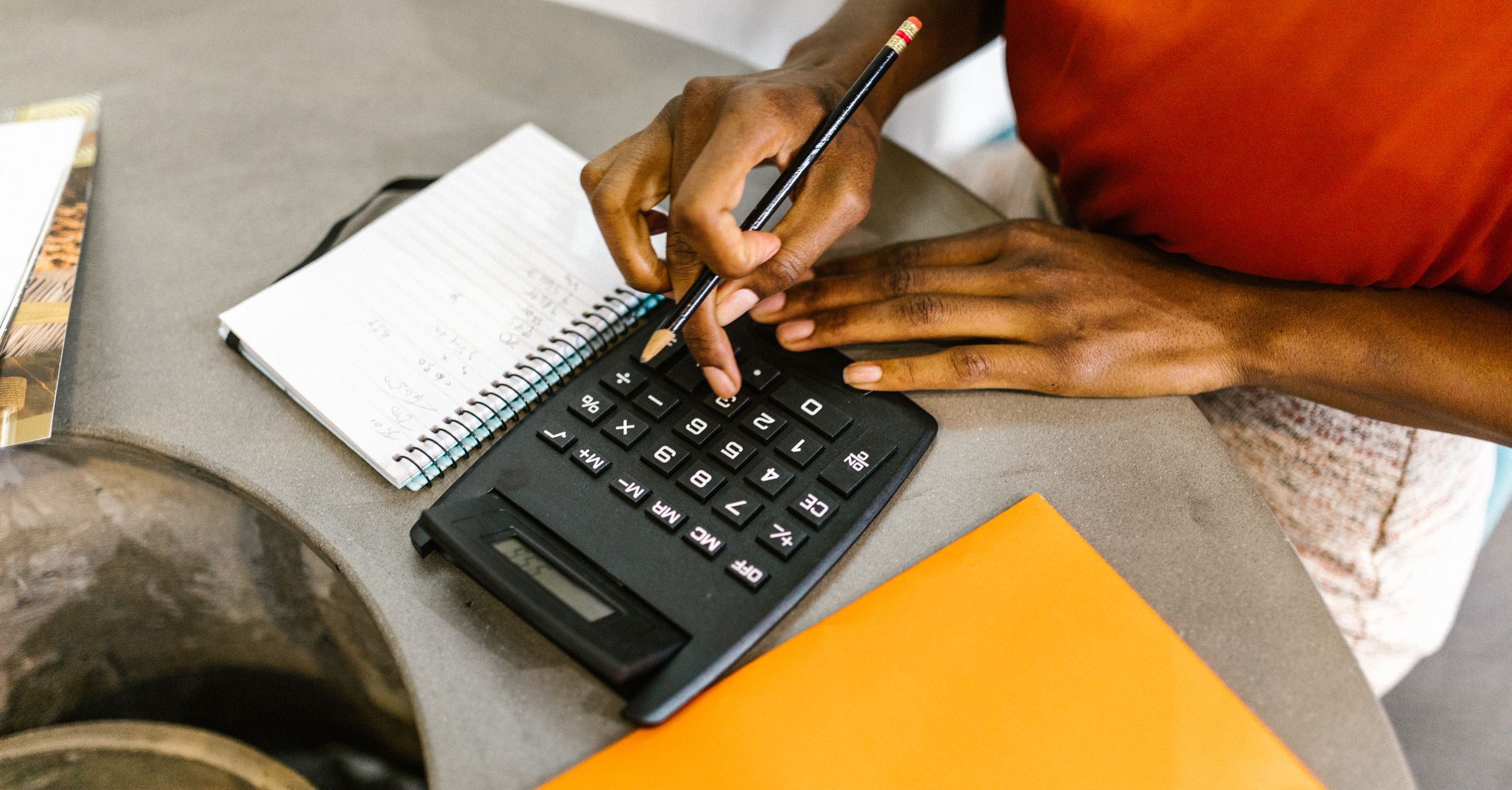 Estimator using a calculator and notepad for AI estimating assistance