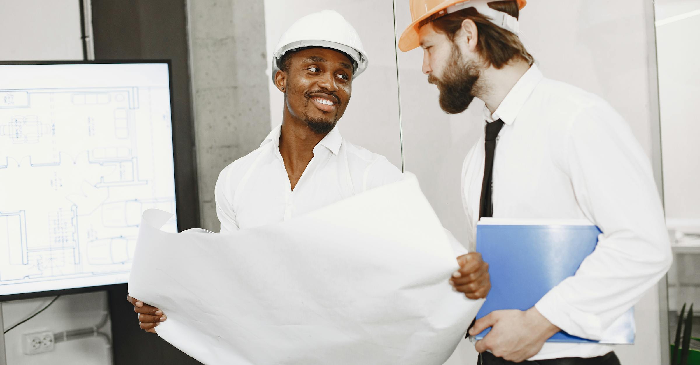 Contractors reviewing architect plans for construction bid management