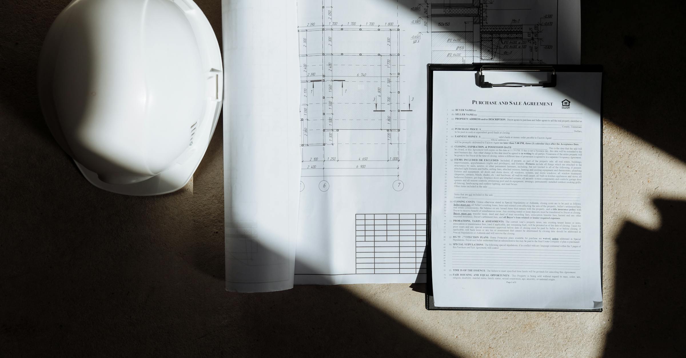 Construction contract documents and floor plans for change order review