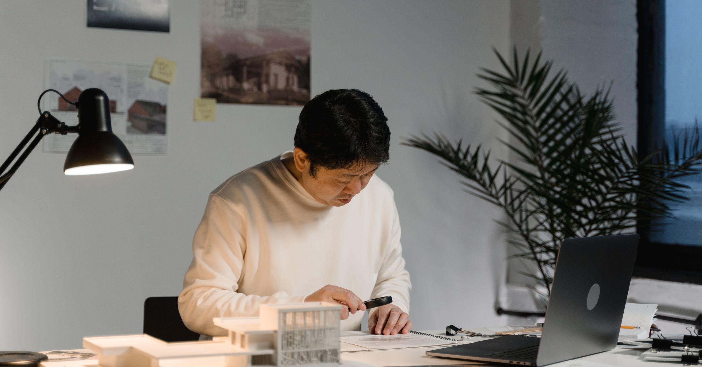 Architect desk with building model and documents for permit status tracking
