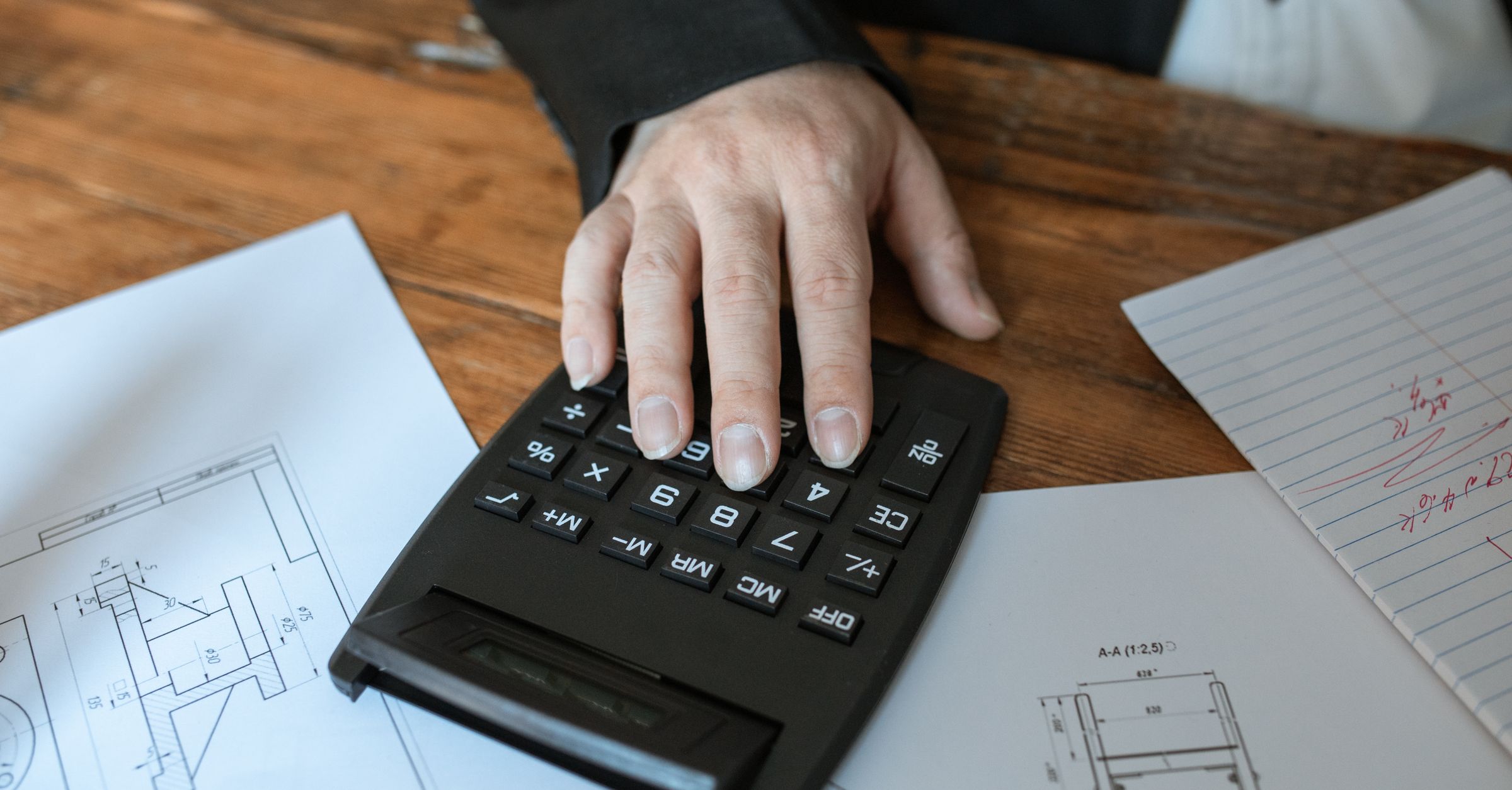 Calculator on architectural plans for construction procurement and purchase order control