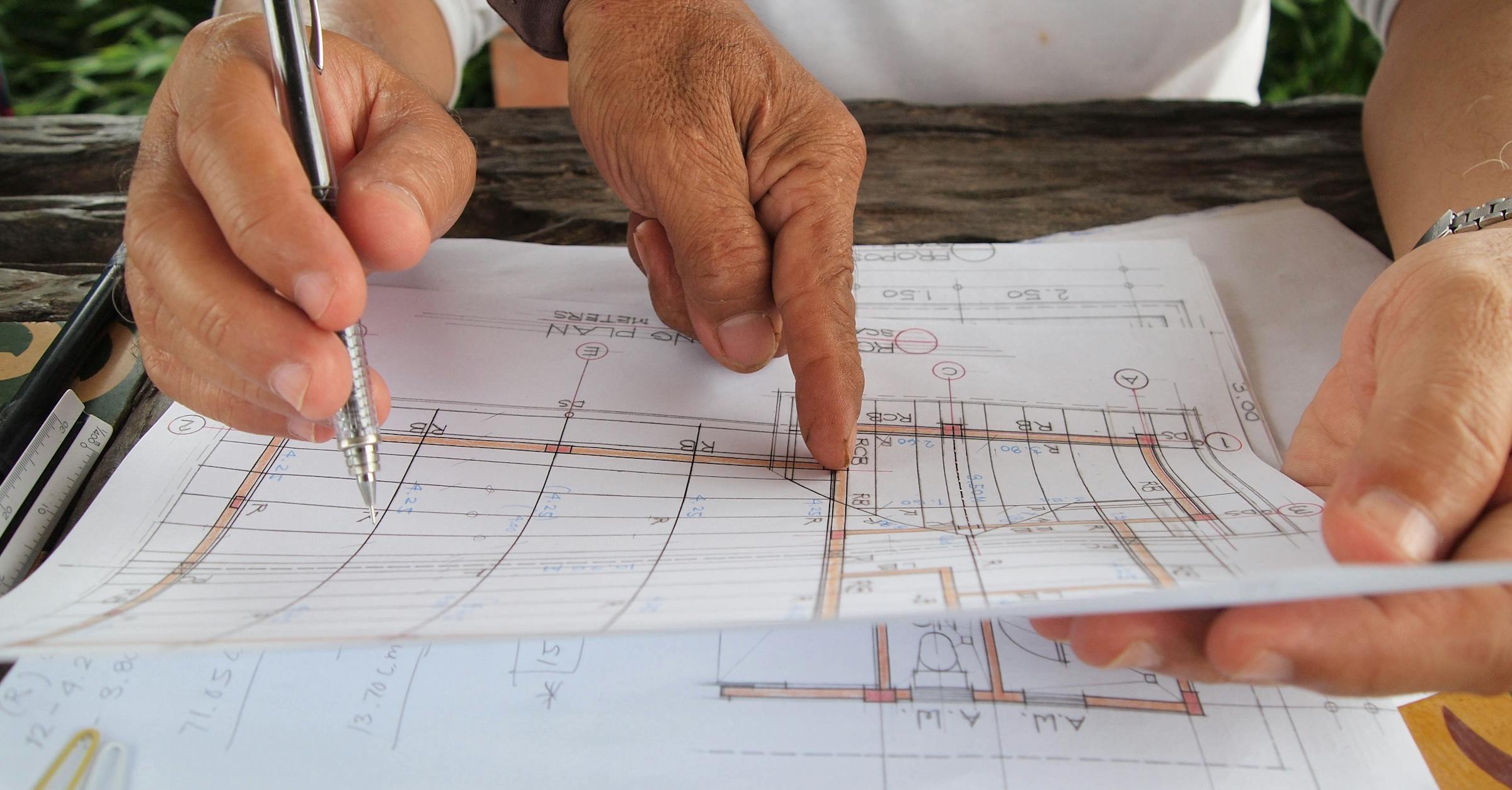 Architects reviewing blueprints for construction RFI coordination