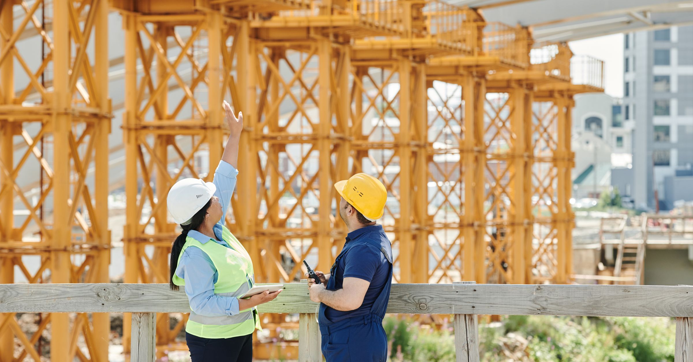 Construction site supervisor using a tablet to inspect work progress